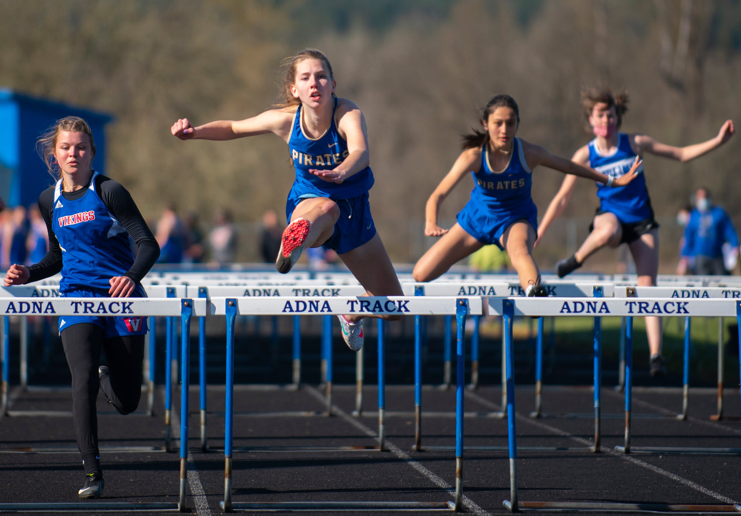 Adna's Faith Wellander leaps over the final 100-meter hurdle before crossing the finish line first on Tuesday in Adna.