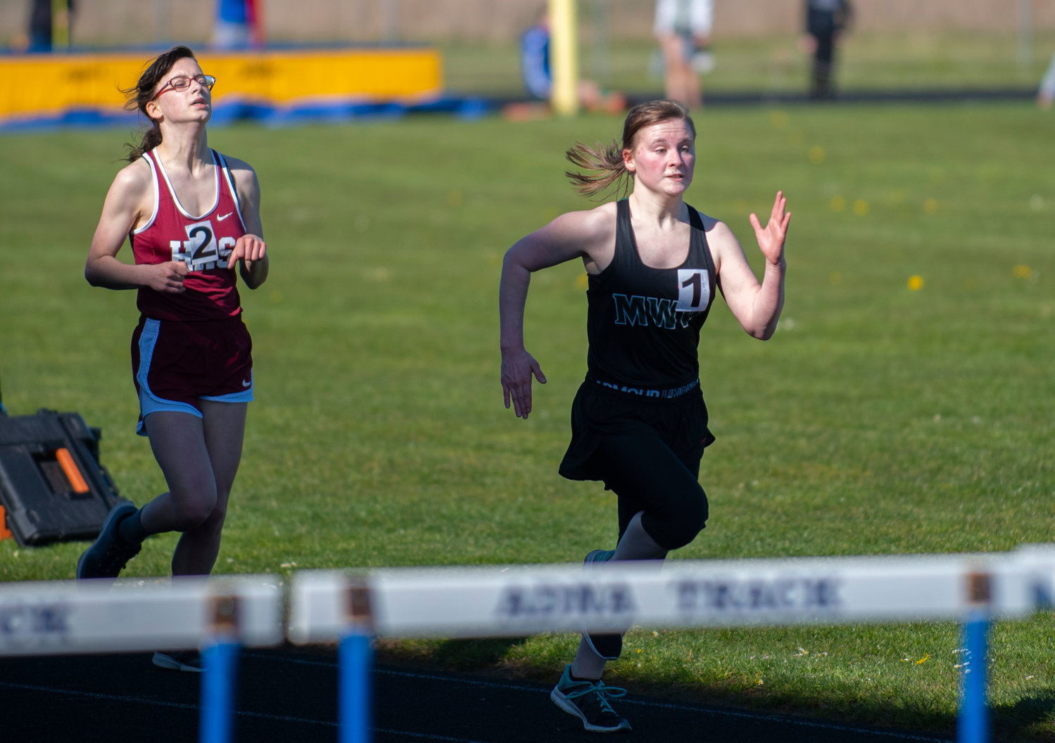 Morton-White Pass sophomore Ayricka Hughes, right, passes a Hoquiam runner in the final 50 meters of the girls 3200-meter run to finish in second place.