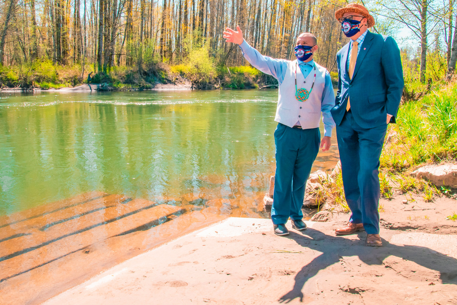FILE PHOTO — Willie Frank III talks to Gov. Jay Inslee about his father Billy Frank Jr. and the Nisqually River behind the Wa-He-Lute Indian School at Frank’s Landing earlier this year.