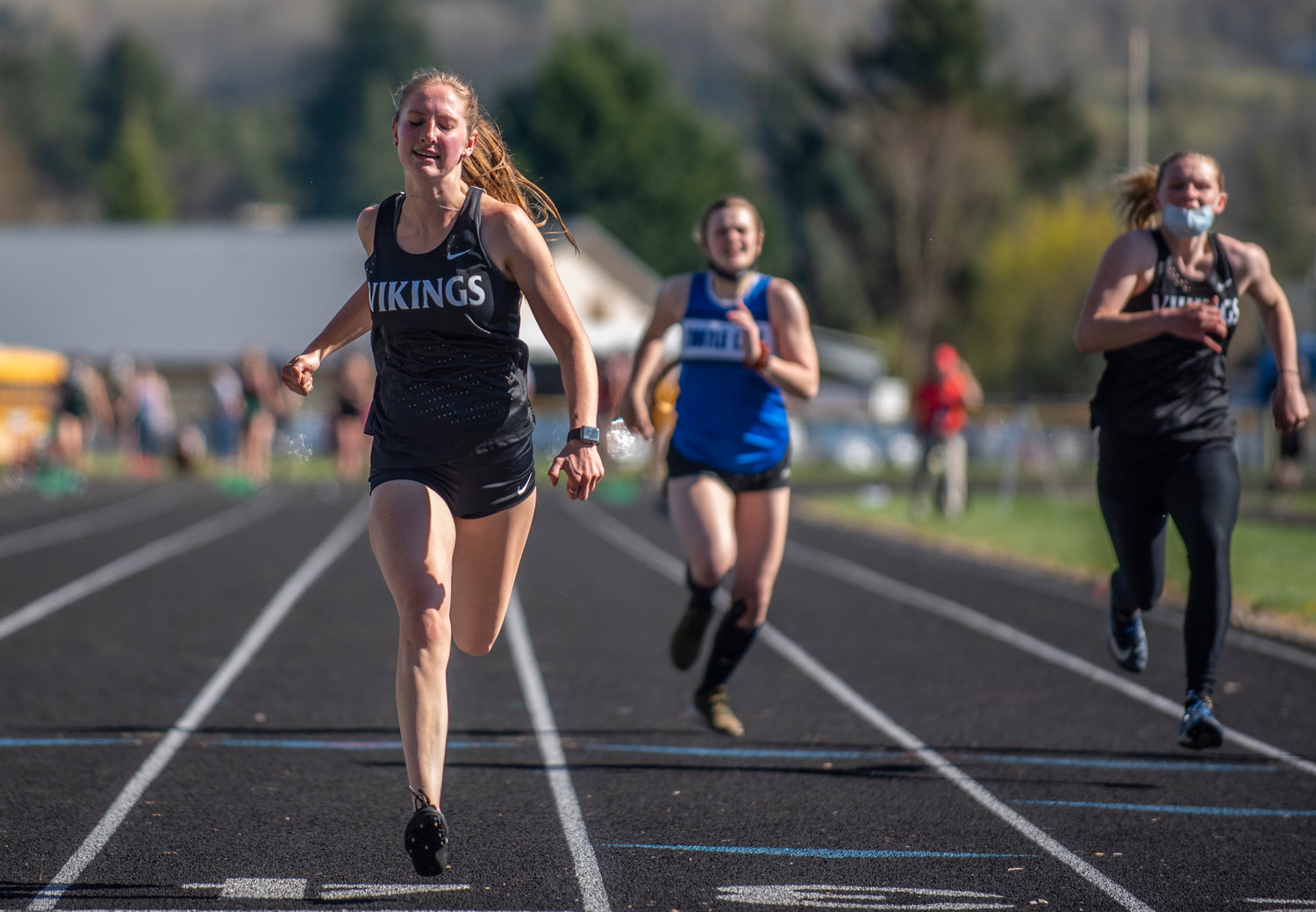 Mossyrock's Teaguen Weise, left, crosses the finish line in the girls 100-meter dash at home on Thursday.