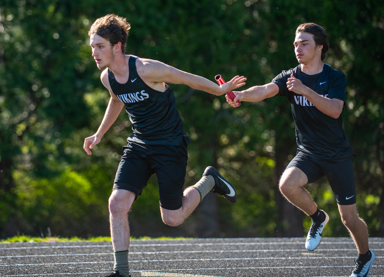 Mossyrock's Kayson Purdy, right, hands off to Aiden Imes in the boys 4x100-meter relay on Thursday at home. The Vikings won the event in 48.15 seconds.