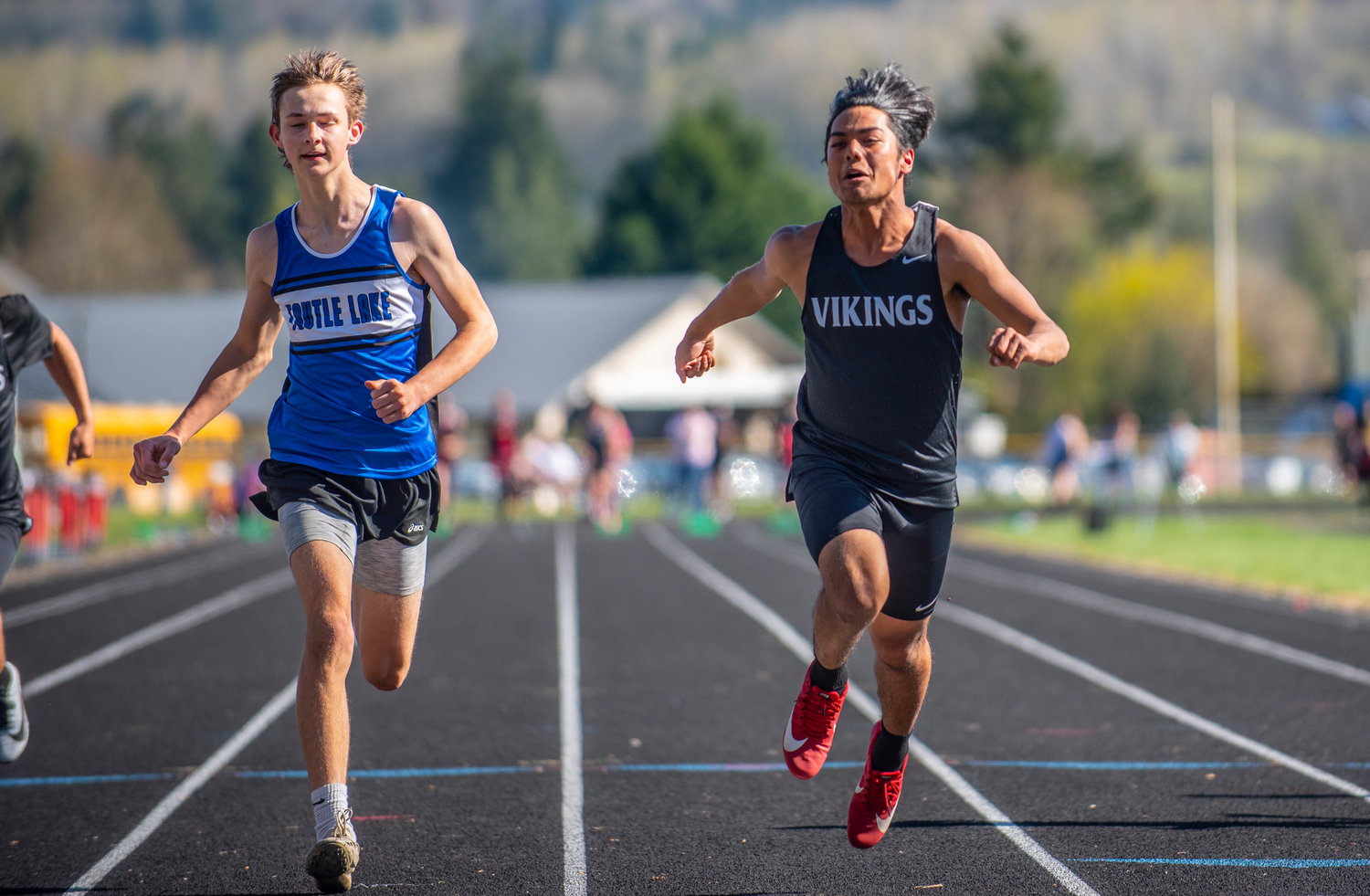 Mossyrock's Tevita Stajduhar, right, wins the boys 100-meter dash at a home meet on Thursday. Stajduhar won a total of three events.