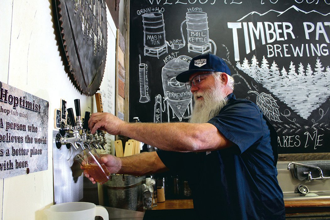 Jim Judd pours a beer at the Timber Patch Brewery Taproom in Morton.