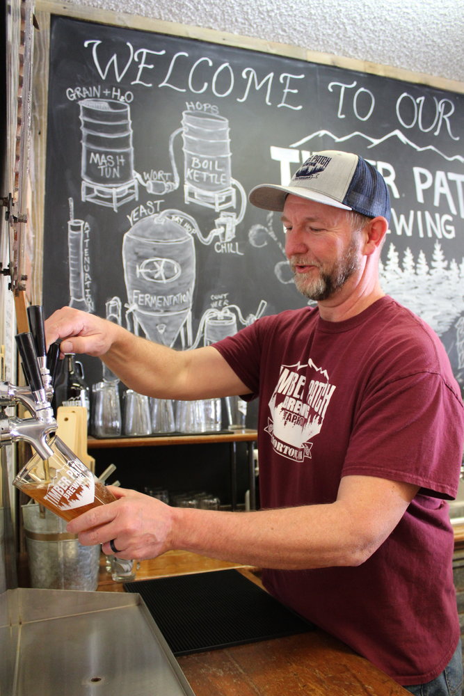 Rich French pours a beer at Timber Patch Brewery Taproom in Morton.