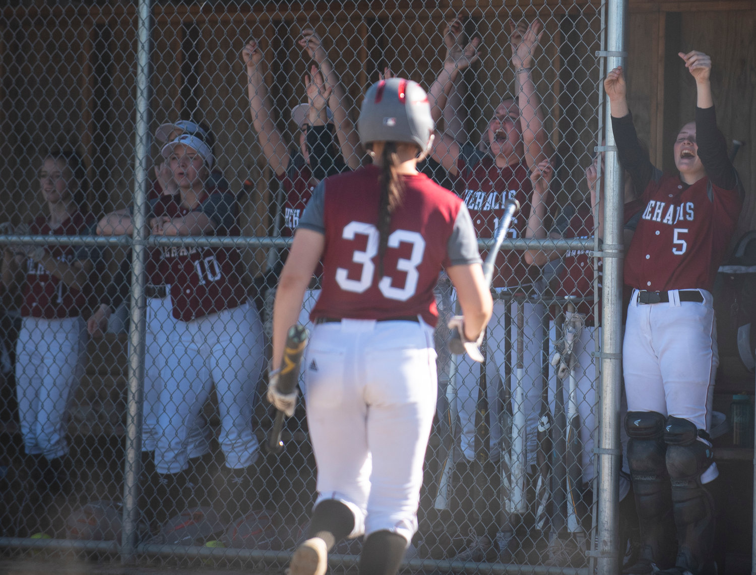 W.F. West's dugout erupts in cheers after Alisha Anderson's standup triple in the third inning.