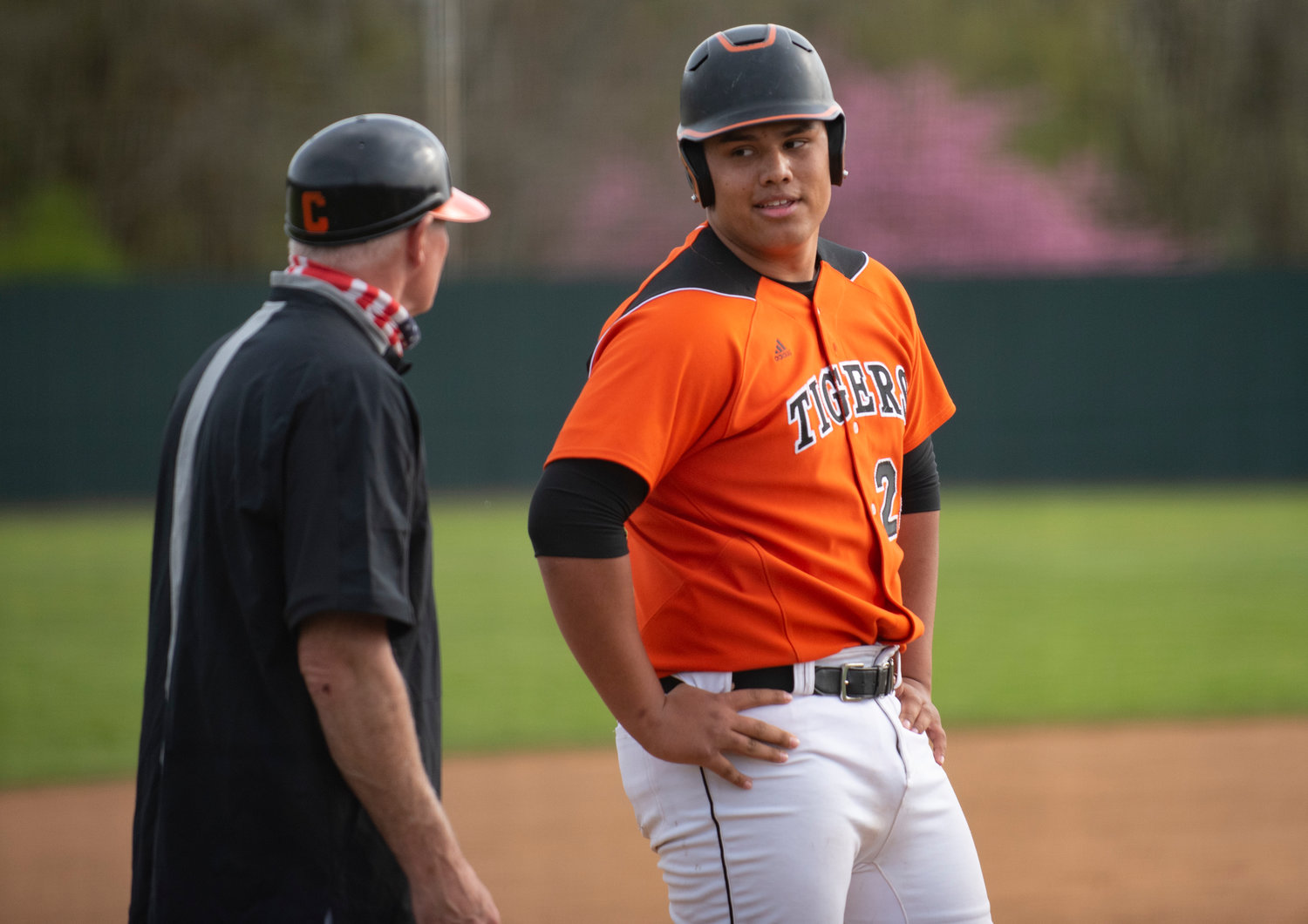 Centralia senior Benito Valencia talks to an asisstant coach after swiping third base against Shelton on Monday.