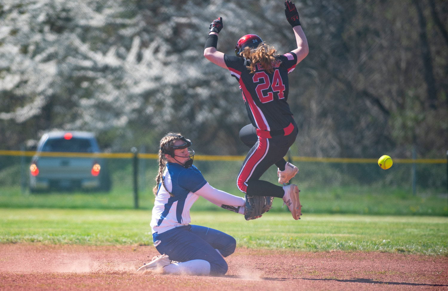 Tenino's Abby Severse (24) leaps over a pickoff attempt while stealing second base on Tuesday.