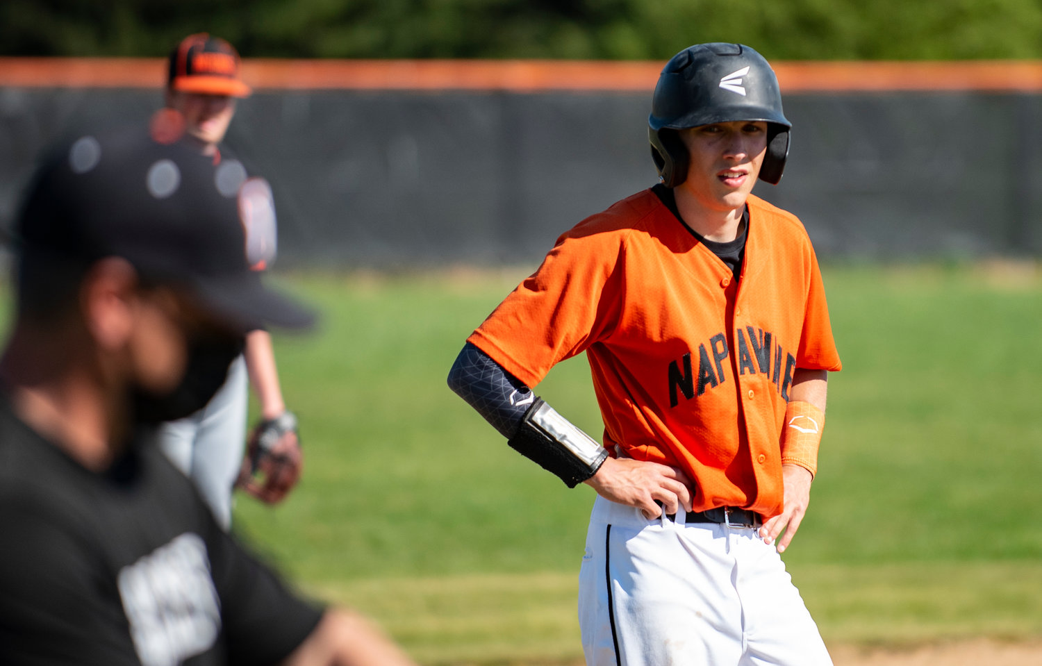 Napavine senior Laythan Demarest sits on third base moments before scoring a run for the Tigers against Kalama Tuesday.