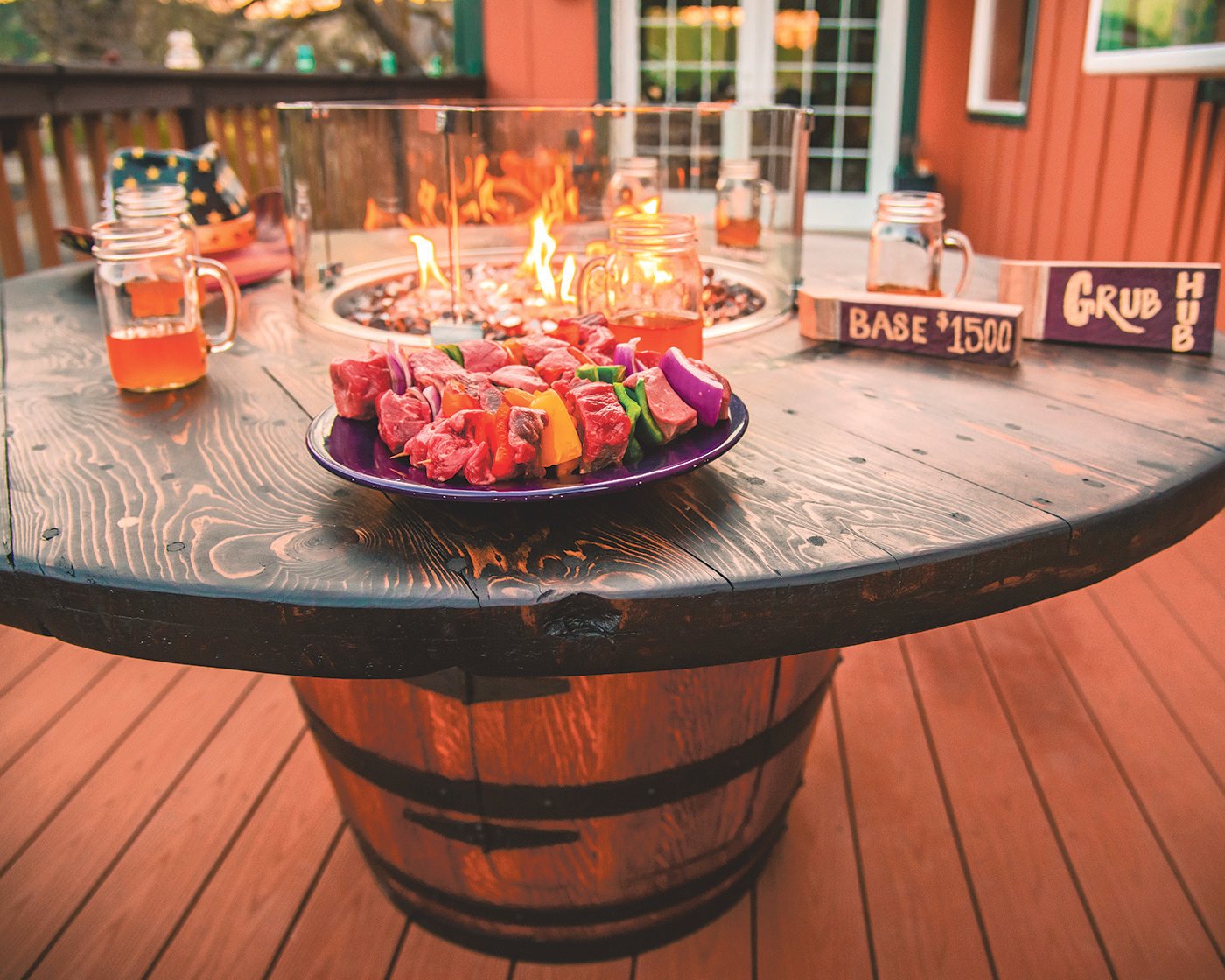 Flames rise as shish kabobs sit on a Bolan “Grub Hub” Barrel at Ron Bolan’s house in the Boistfort Valley Tuesday evening