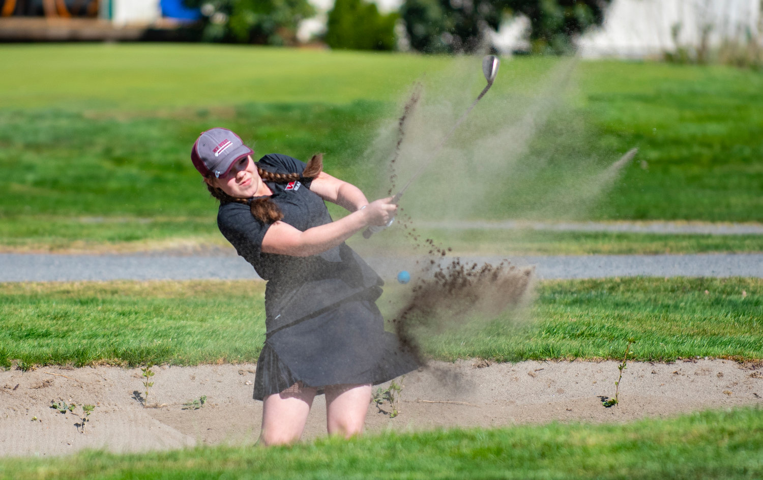 W.F. West's Makenna Klovdahl hits out of the sandtrap at Newaukum Valley Golf Course on Wednesday.