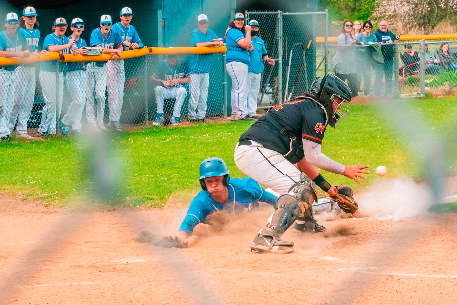 Adna’s Levi Gates (24) slides in safe to score during a game against Kalama Thursday afternoon.