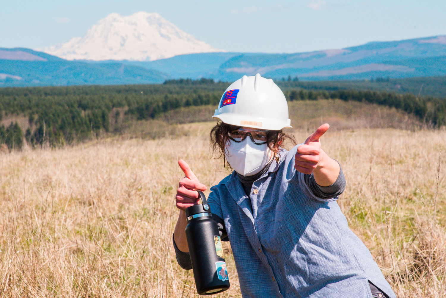 Chronicle reporter Claudia Yaw gives thumbs-up at TransAlta Centralia earlier this month while sporting her personal protective equipment.