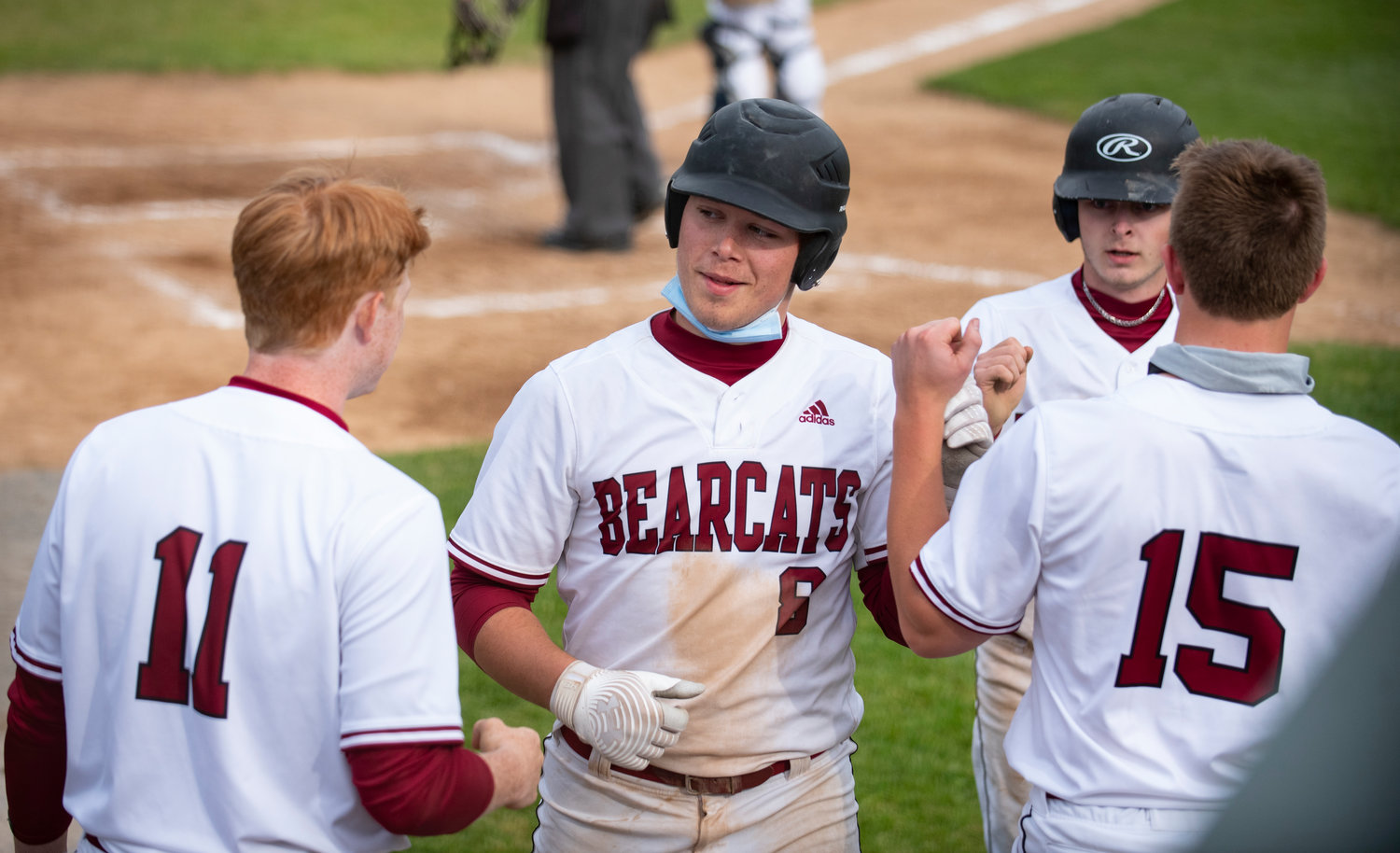 W.F. West senior Brit Lusk (8) is congratulated after scoring a run against Aberdeen on Friday.