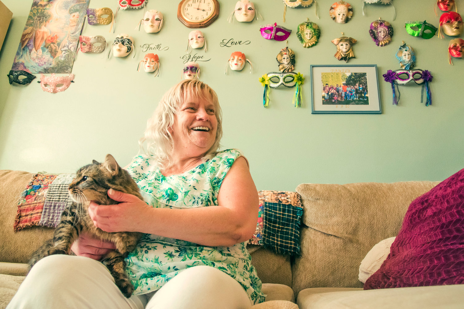Debbie Nix laughs while petting her cat KJ in her Centralia residence.