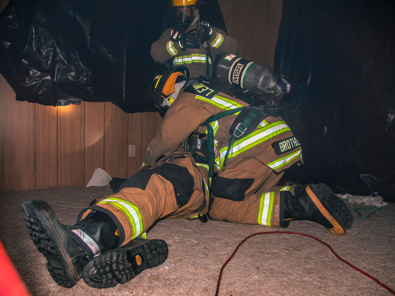 Firefighters trained using a fog machine to help simulate smoke. The building was also darkened to create a more realistic exercise for firefighters.