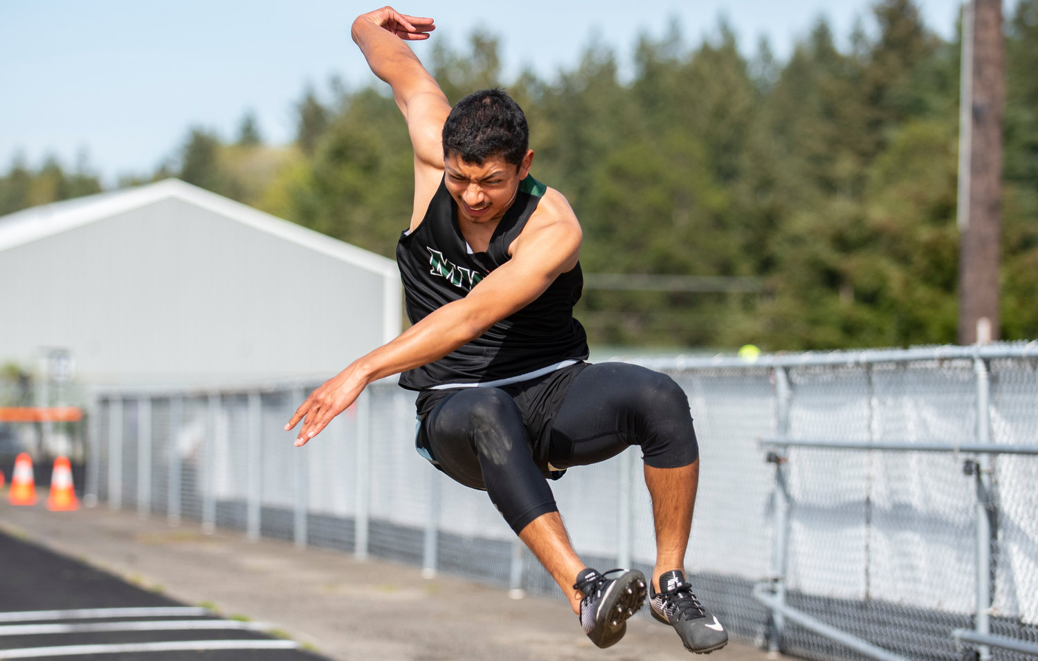 Morton-White Pass' David Martinez takes off in the boys long jump at the district championships Thursday.