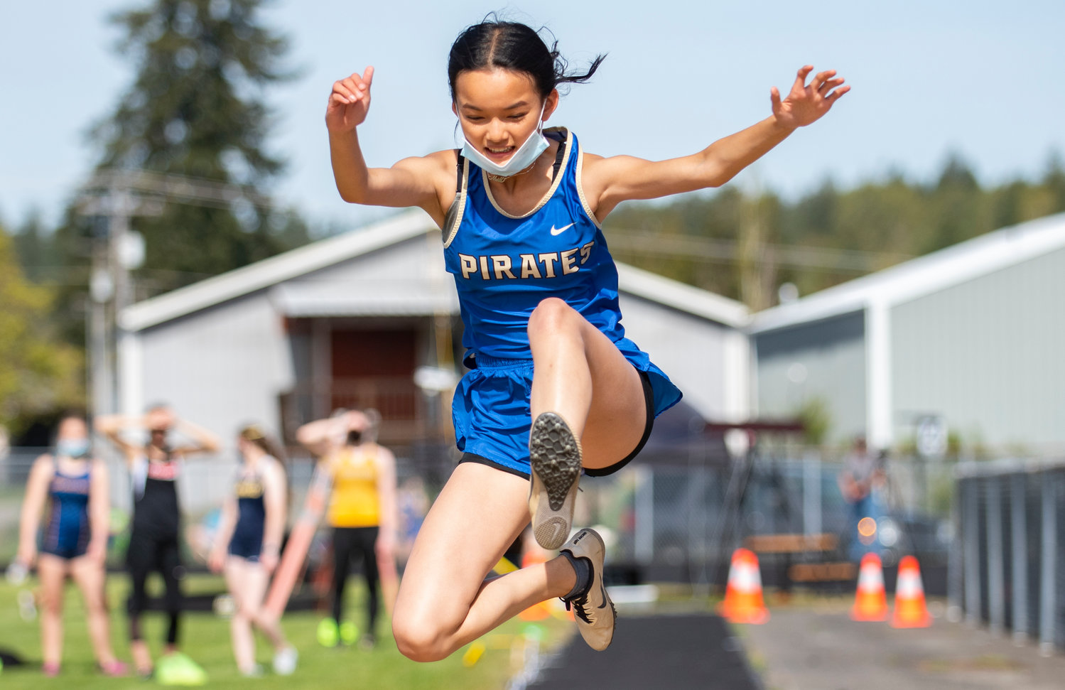 Adna's Meili Wolf catches air in the girls long jump at the district championships on Thursday.