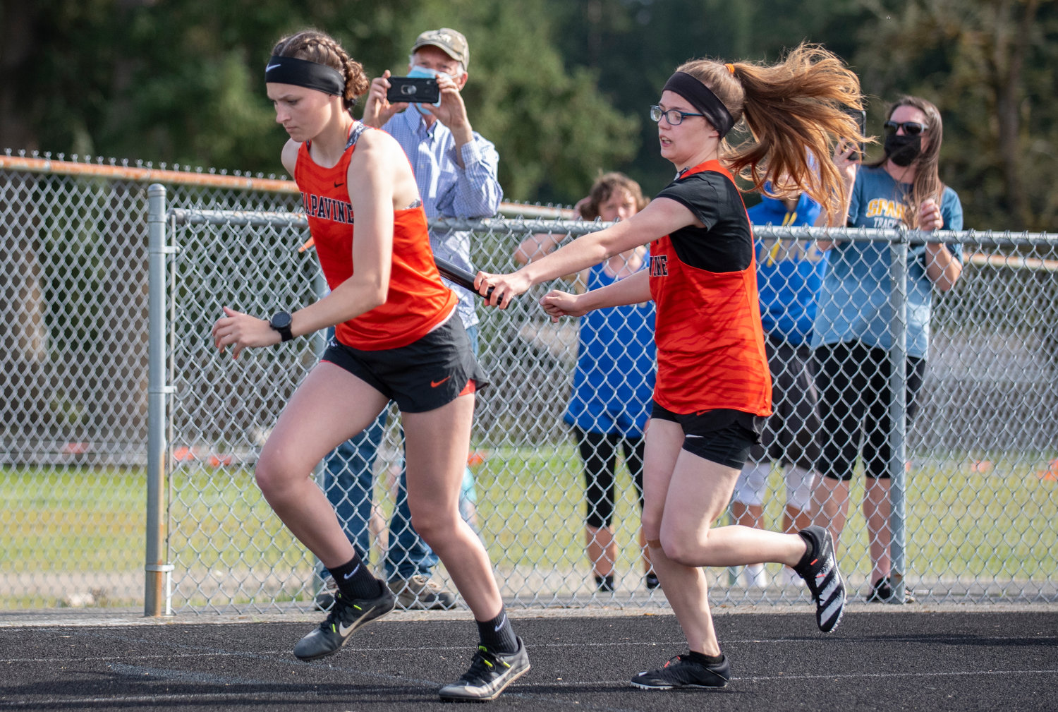 Napavine's Nikki Ahmann, right, hands off to Chloe Ford in the girls 4x200 relay on Thursday.