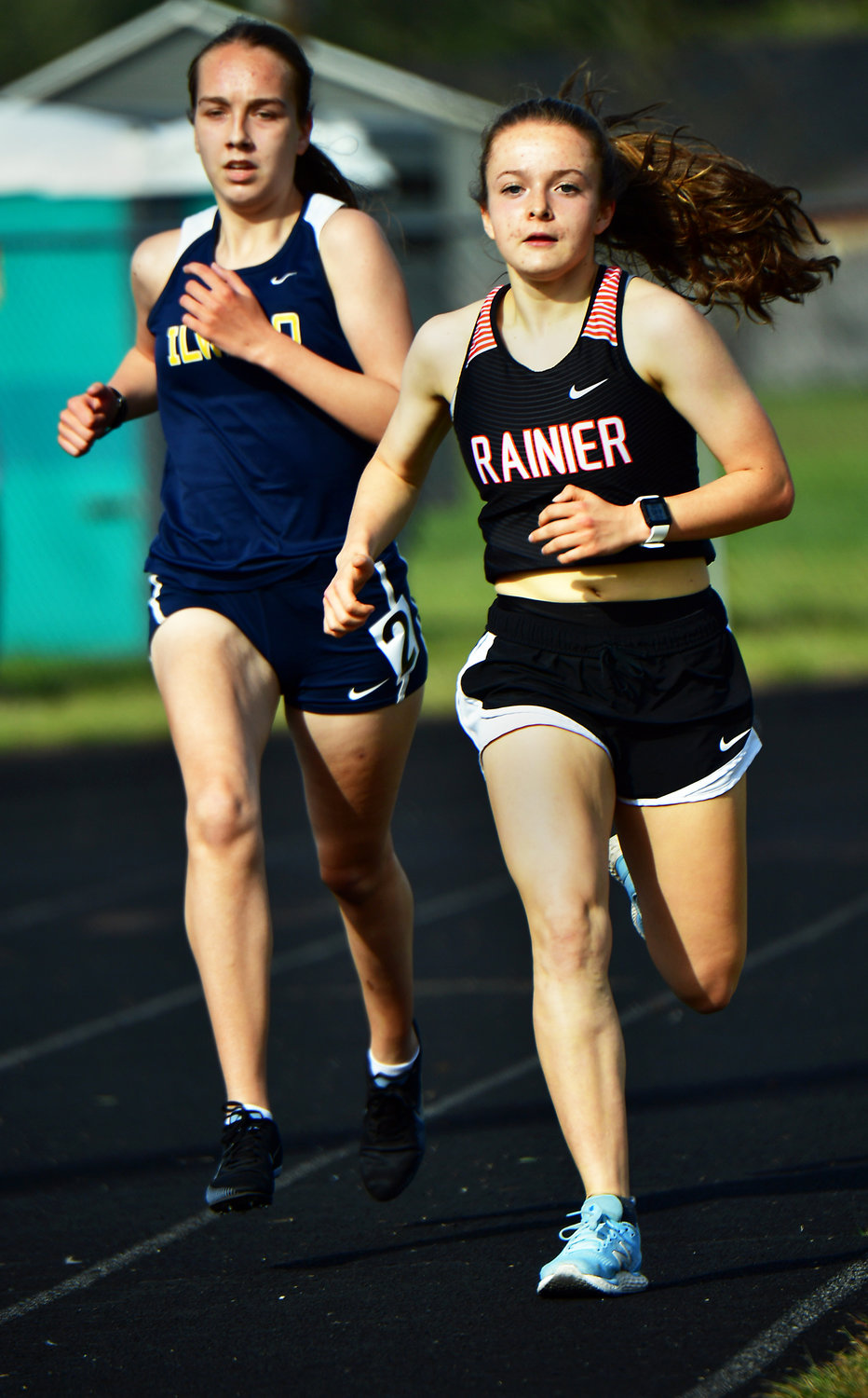 Rainier High School’s Selena Niemi, right, goes on to win the 1,600-meter run on Thursday, April 29, during the WIAA District 4 Track & Field Championships at Rainier High School.