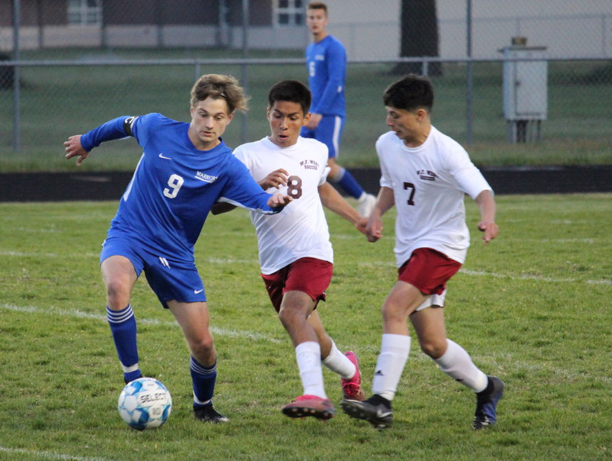 Rochester's Levi Jennings (9) battles with W.F. West's Elvis Leal-Perez (8) and Saul Lima-Perez (7) during a match on Thursday.