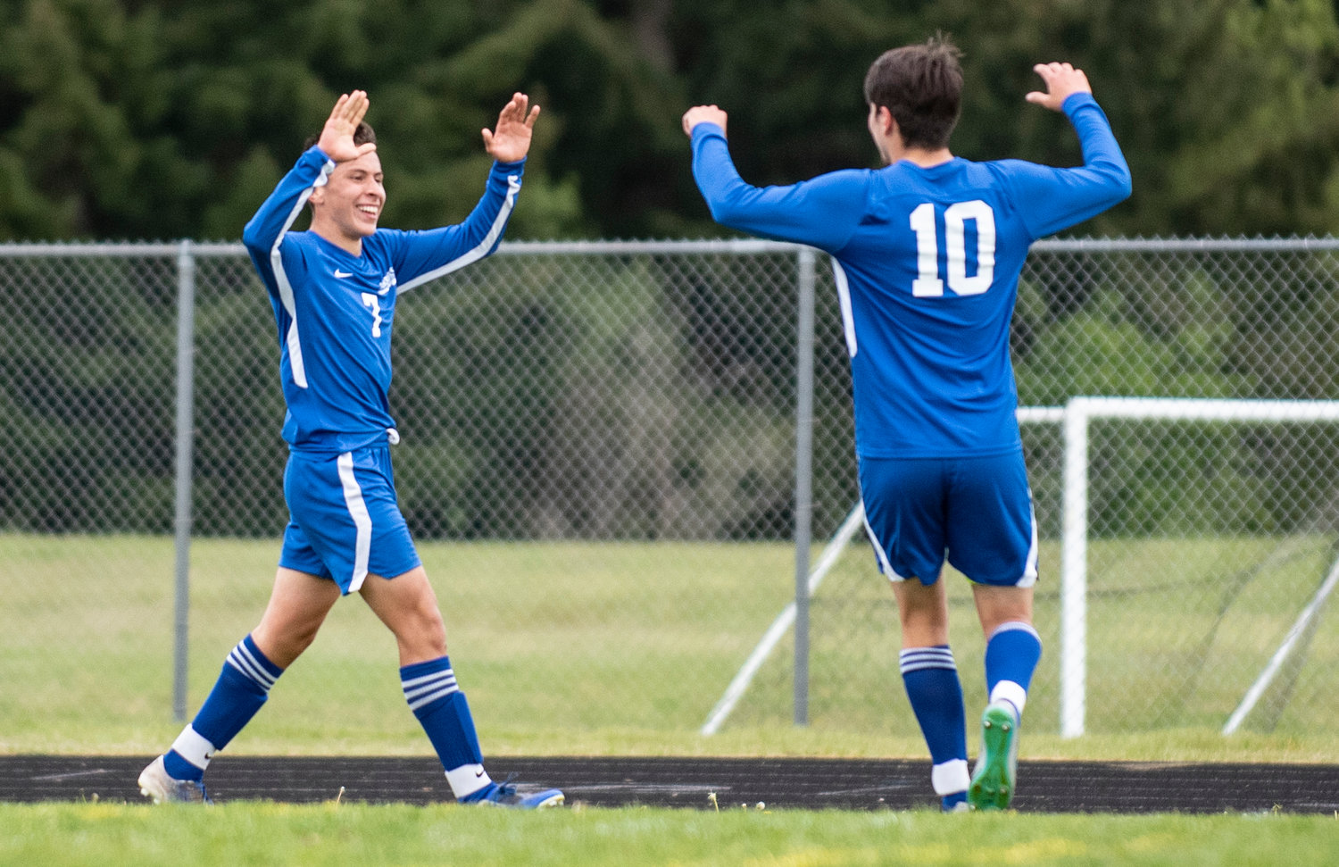 Rochester's Alexis Castillo-Corona (7) high-fives Erik Vasquez-Valentine after scoring a goal to put the Warriors up 2-0 in the first half against Centralia in the opening round of the 2A EvCo playoffs Saturday at home.