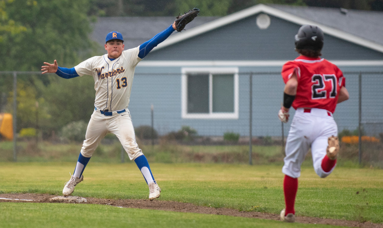 Rochester first baseman Eddie Burkhardt (13) stretches to make the out at first base against Shelton on Monday.
