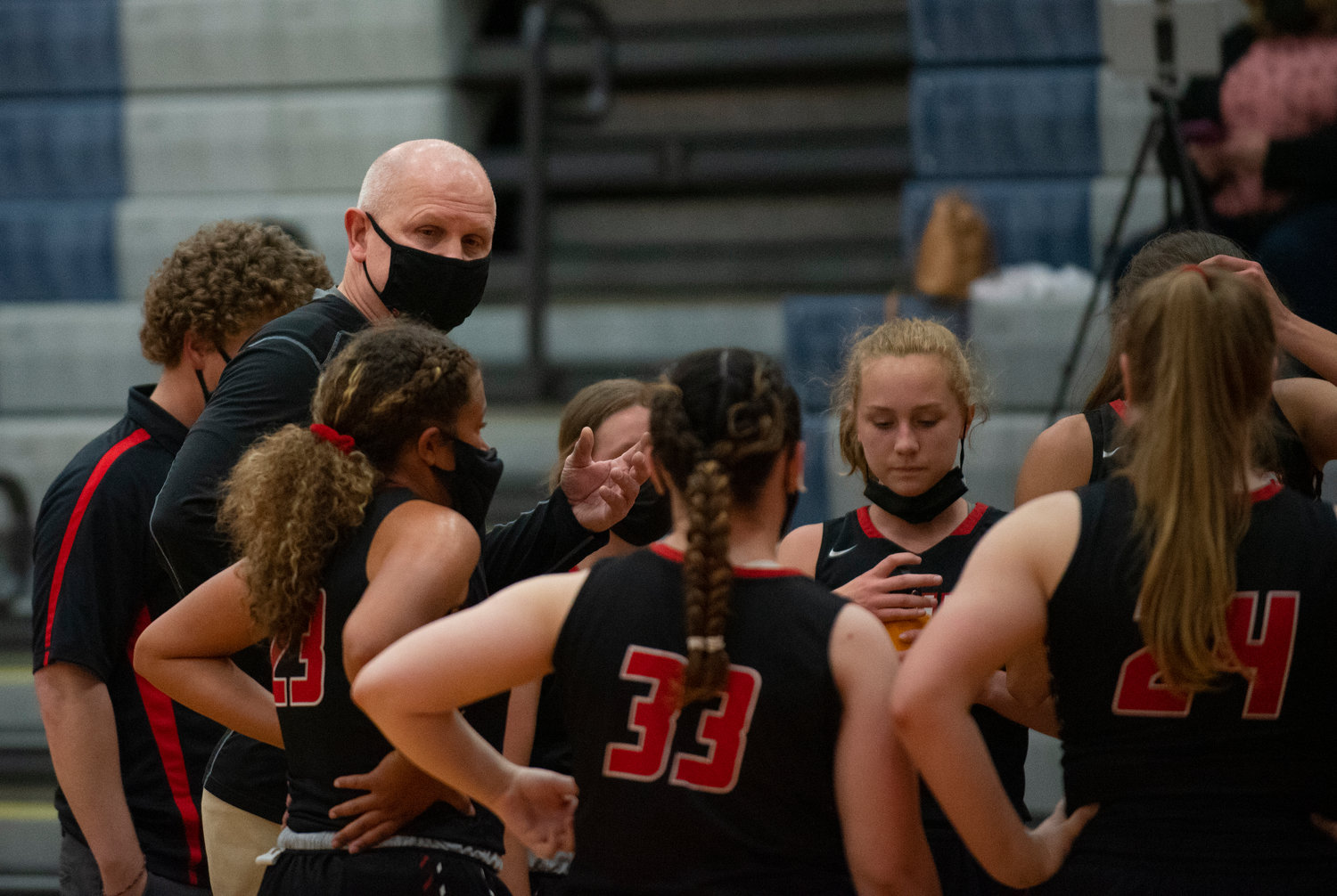 Tenino coach Scott Ashmore talks to his team during a 60-second timeout in a game against Rainier on Monday.