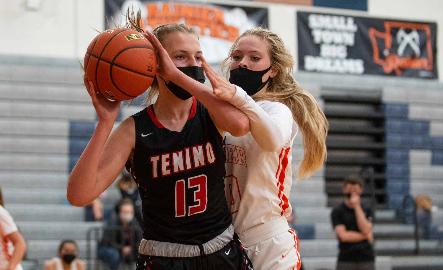 Tenino's Rylee Jones (13) looks for an open pass while Rainier's Isabella Holmes defends.