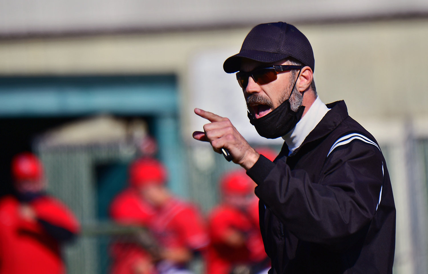 A member of the umpire crew admonishes the W.F. West High School coaching staff for arguing in their 2A playoff game against Shelton High School in Chehalis on Tuesday, May 4.
