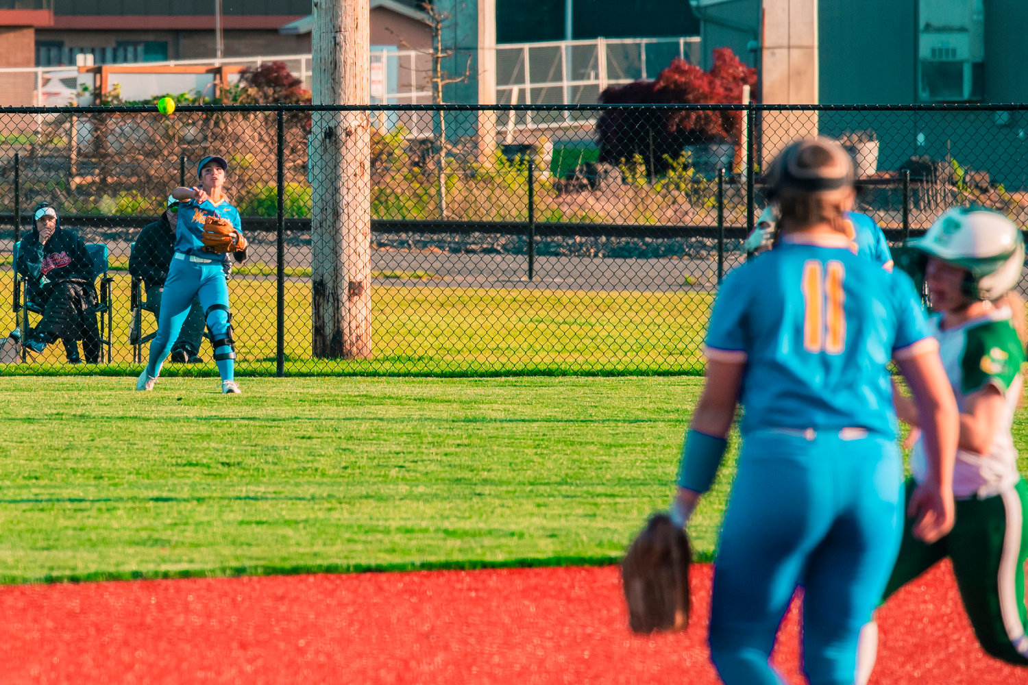 A ball is thrown in from the outfield as players make their way around the bases during a game Tuesday afternoon in Chehalis.