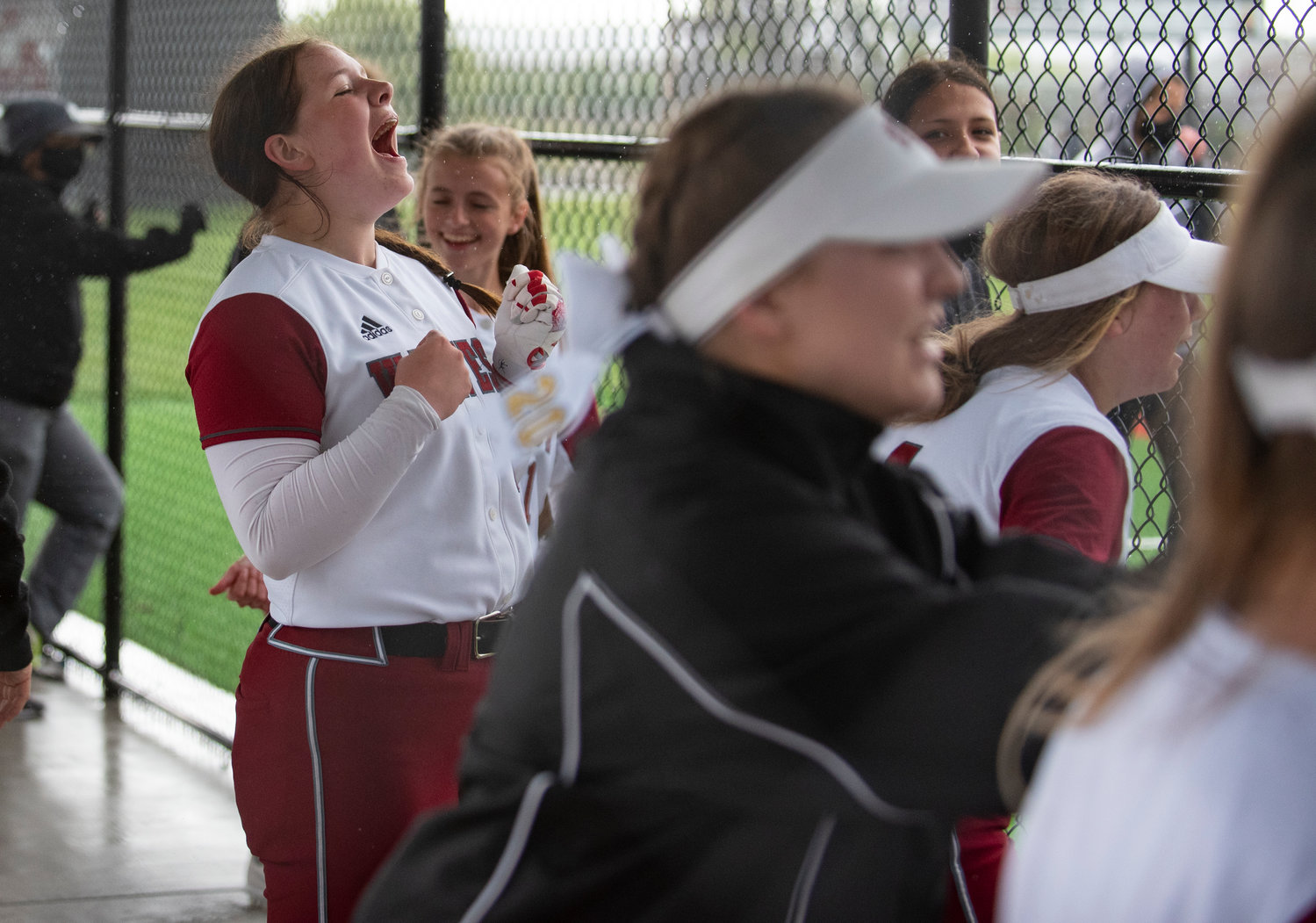 W.F. West sophomore Savannah Hawkins, left, cheers from the dugout during the district title game on Thursday.