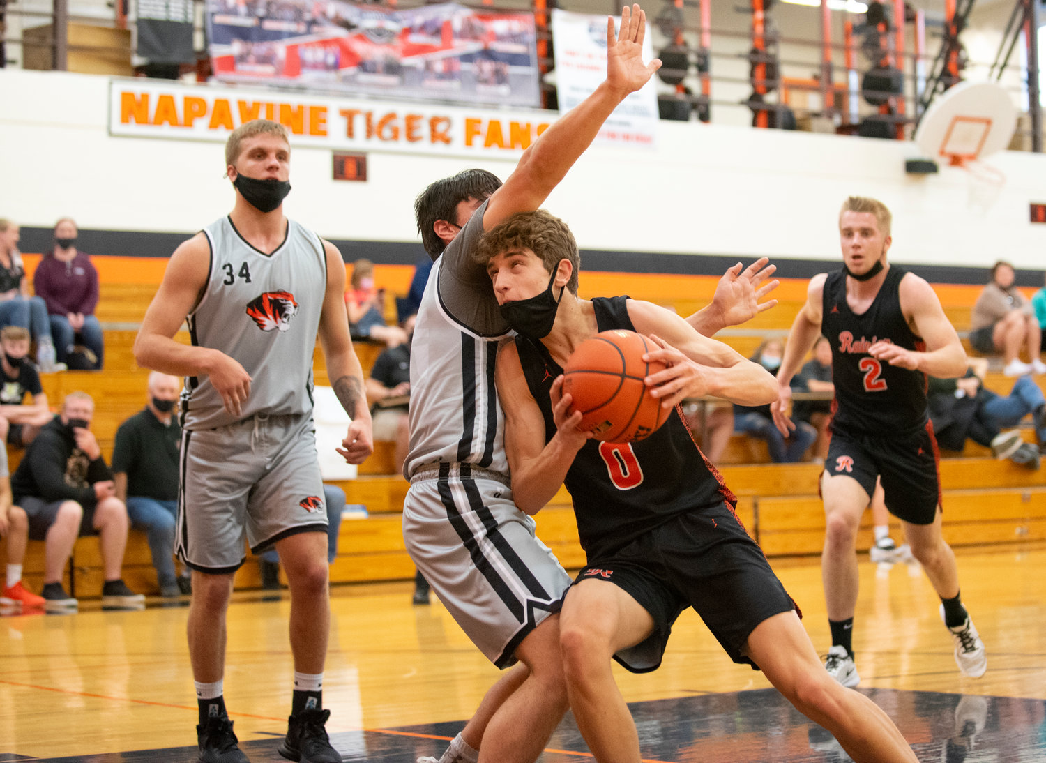 Rainier's Ian Sprouffske takes it to the hoops against Napavine's Gavin Parker on Tuesday.