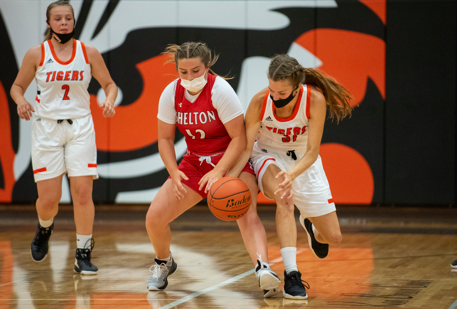 Centralia's Maddie Corwin, right, battles for a loose ball with a Shelton player.