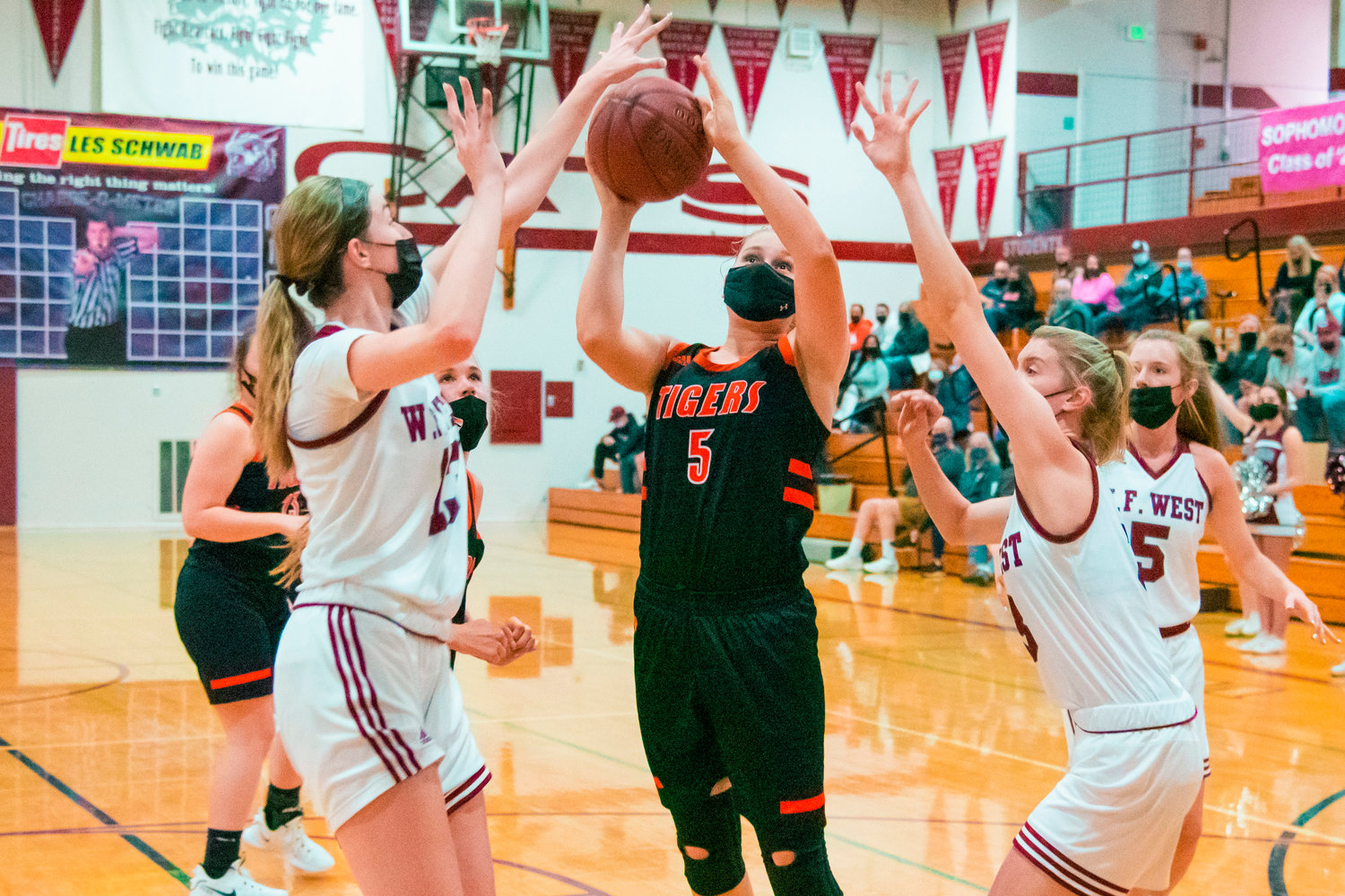 Centralia’s Emily Wilkerson (5) attempts to shoot while surrounded by defenders during a game against the Bearcats played Monday night in Chehalis.
