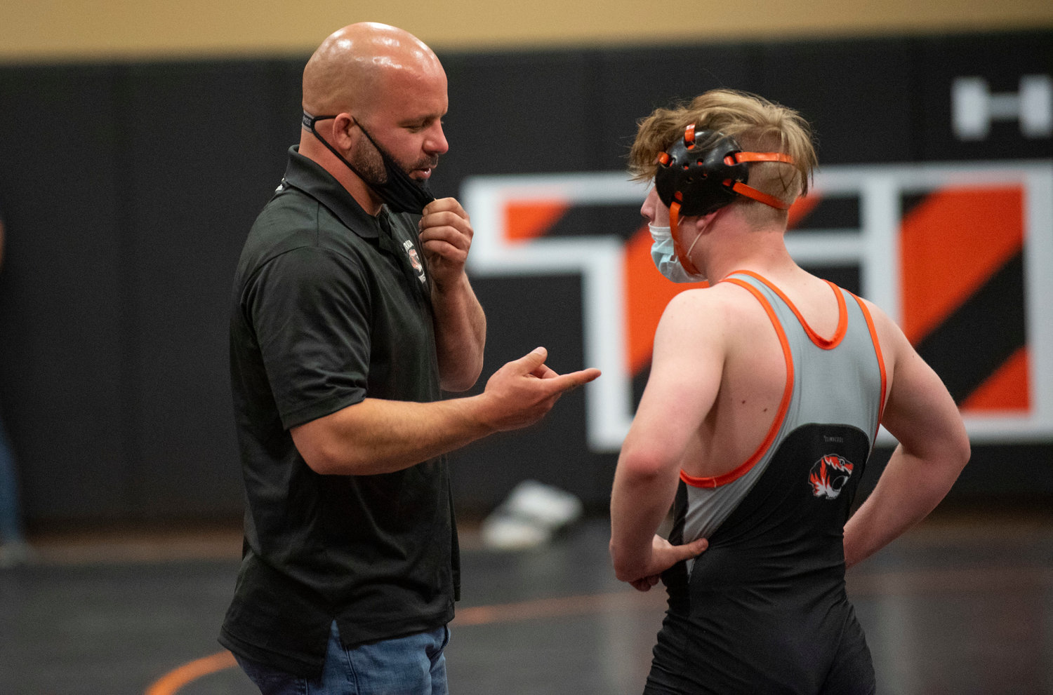 Centralia wrestling coach Scott Phillips, left, talks with a Tigers wrestler between rounds on Tuesday.