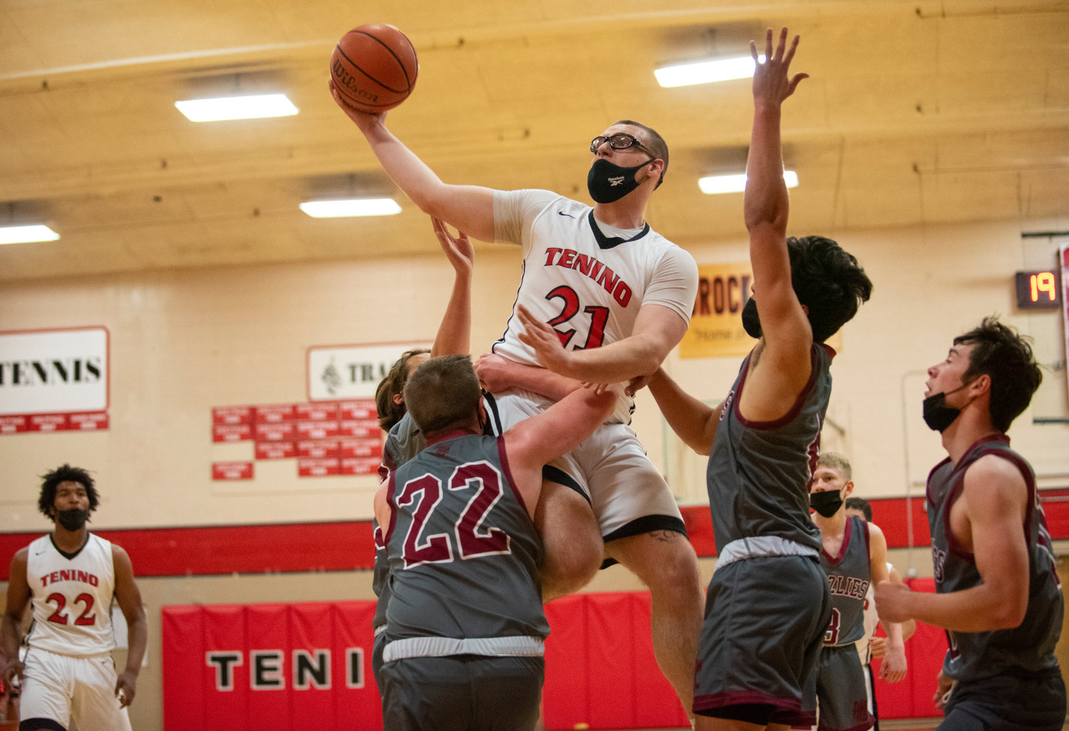Tenino senior Conleth Jackson soars over a Hoquiam triple team for a layup at home on Wednesday.