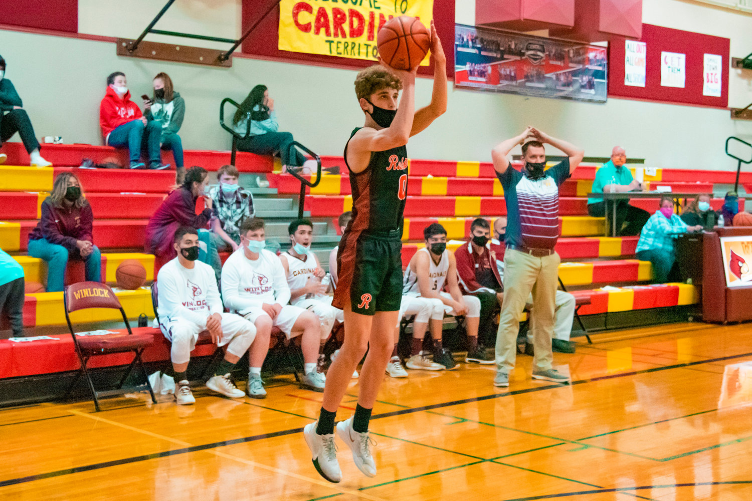 Rainier’s Ian Sprouffske (0) makes a three-point shot during a game against the Cardinals Wednesday evening in Winlock.