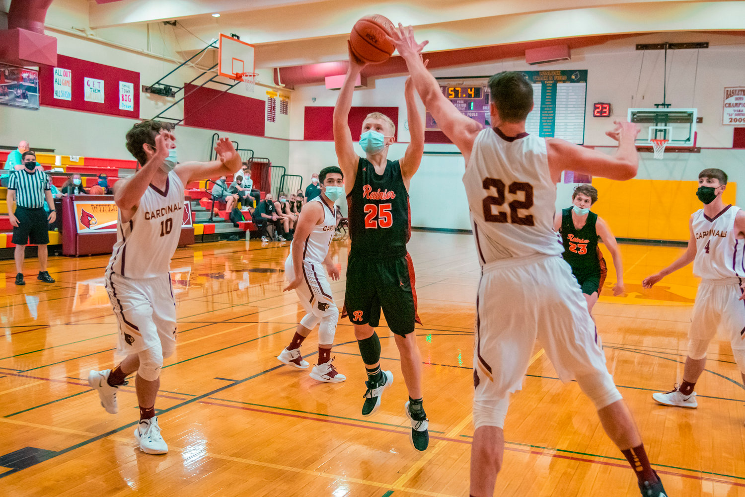 Rainier’s Brody Landram (25) makes a shot over defenders during a game in Winlock on Wednesday.