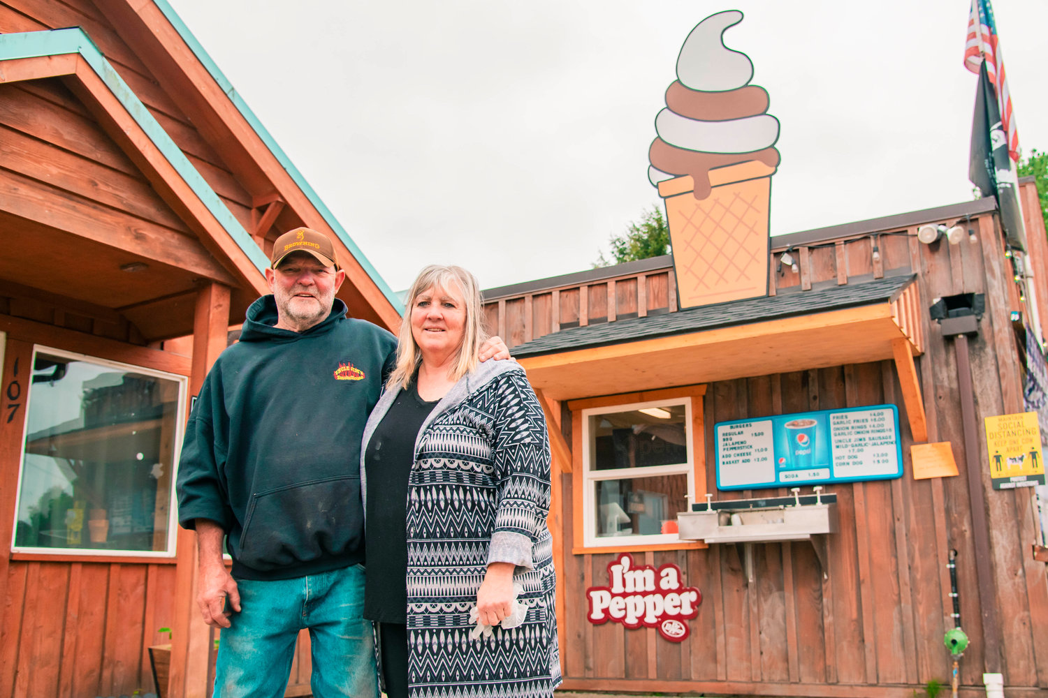 Jim and Cindy Smith smile and pose for a photo in front of the Adna Burger Bar last May.
