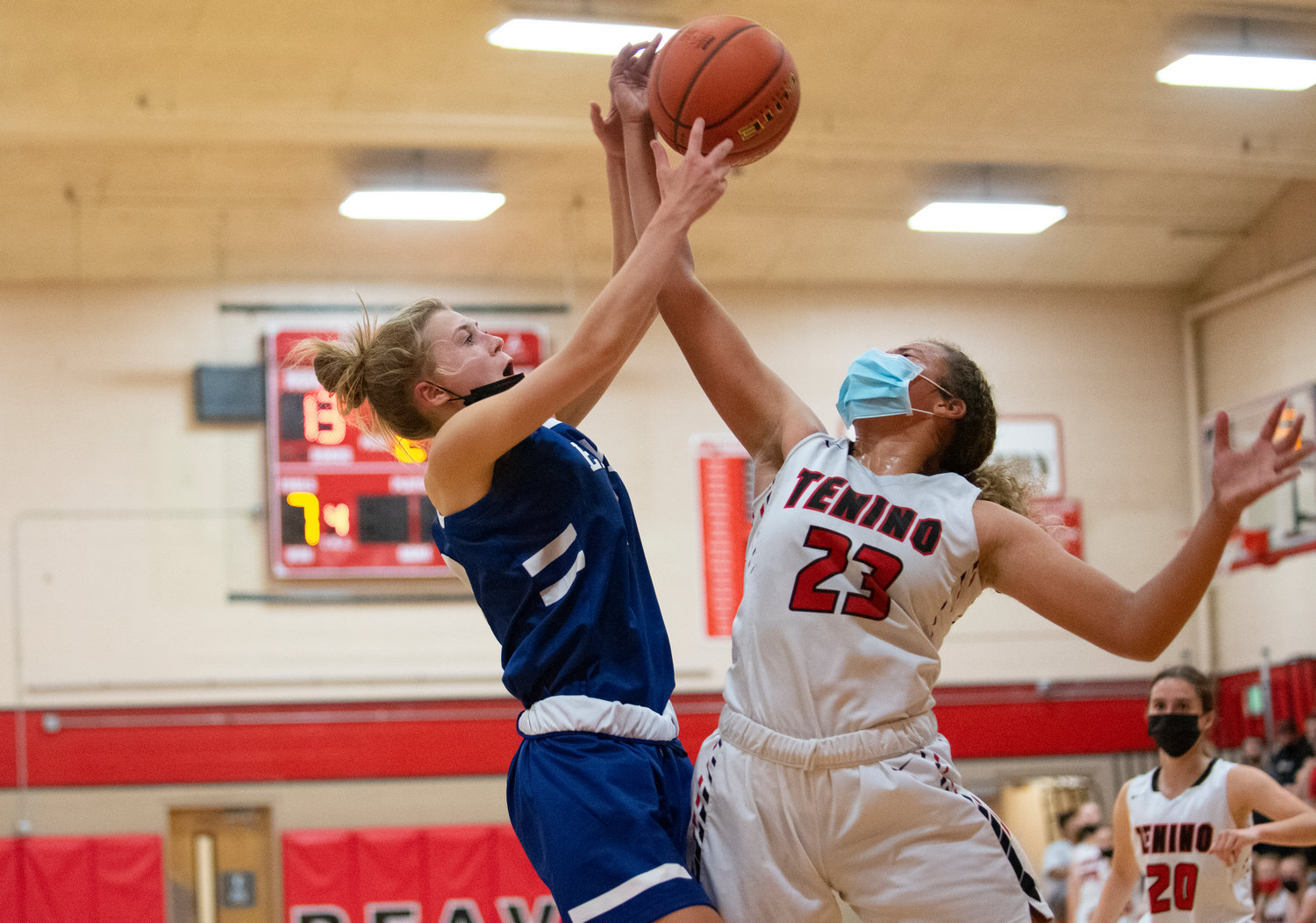 Tenino's Alivia Hunter (23) battles with an Elma player for a rebounds on Saturday.