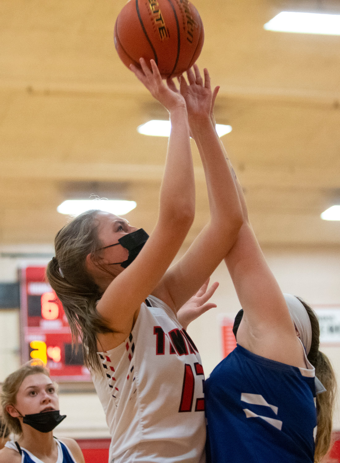 Tenino sophomore Rilee Jones (13) goes up for a shot in the paint against Elma.