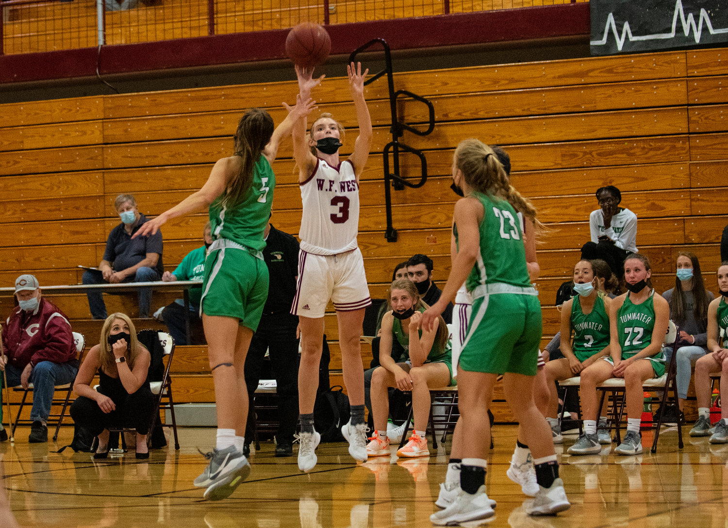 W.F. West's Lexi Roberts (3) puts up a 3-point shot over the hand of Tumwater's Natalie Sumrok (5) on monday.