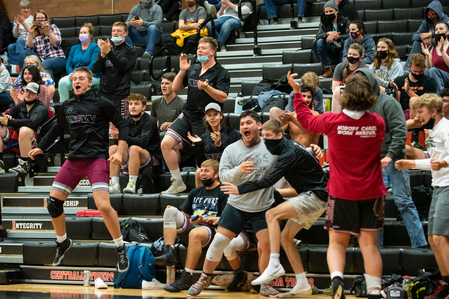 W.F. West wrestlers explode in cheer after freshman Joey O'Neil wins by pin in his first match of the night on Tuesday.