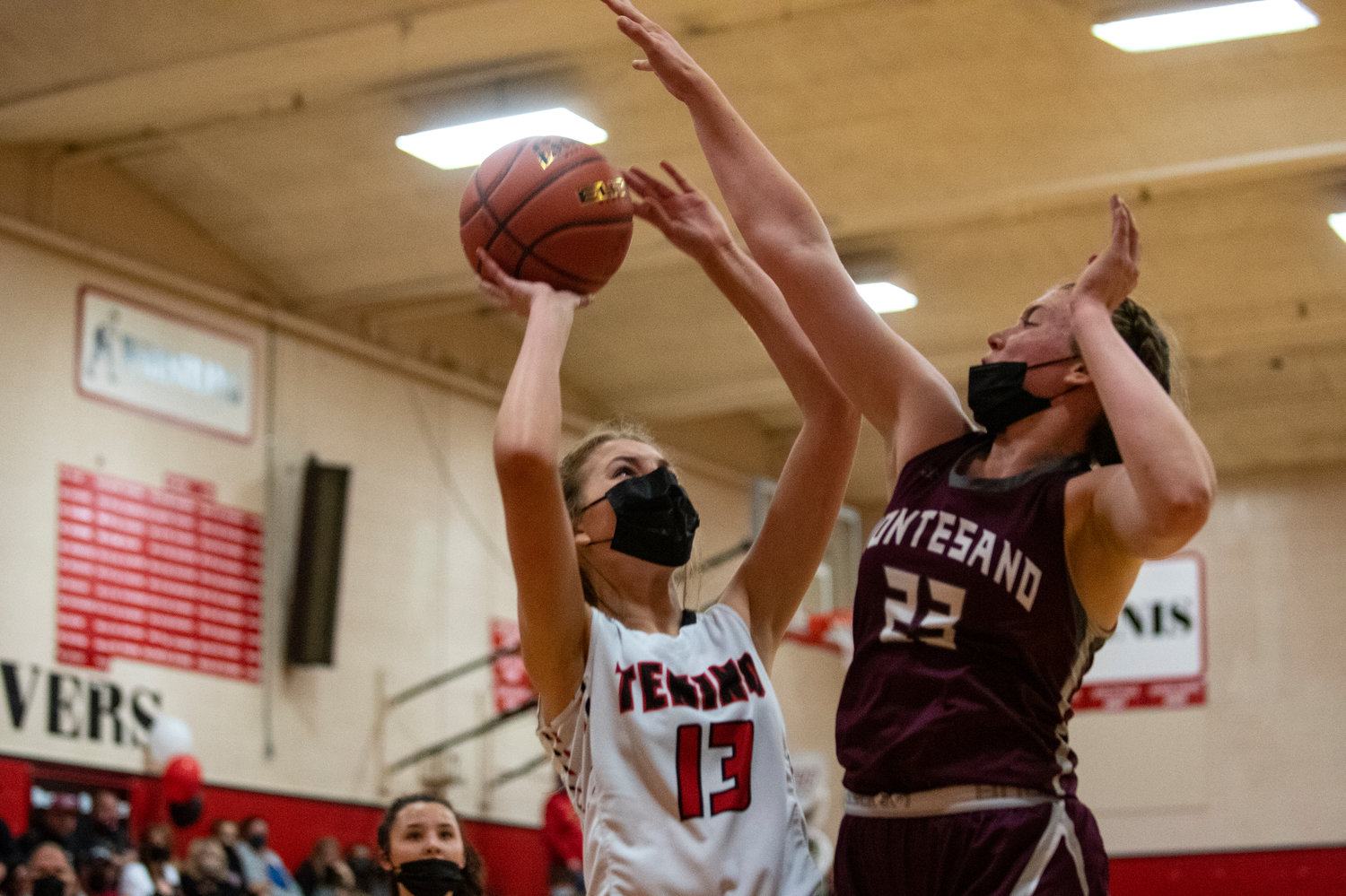 Tenino sophomore Rilee Jones (13) goes up for a shot in the paint against Montesano's Paige Lisherness (23) on Thursday.