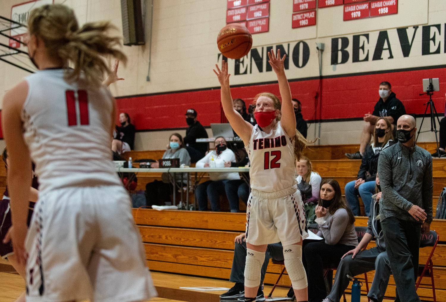 Tenino junior Abby Severs (12) shoots a 3-pointer in front of Montesano's bench on Thursday.