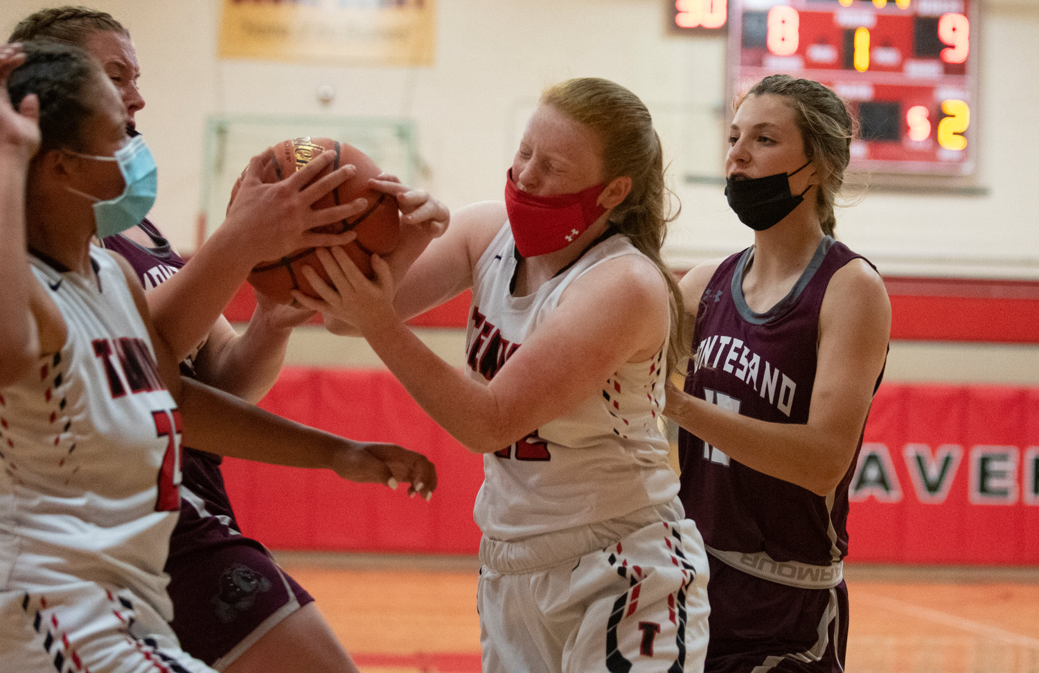 Tenino junior Abby Severse (12) wrestles for an offensive rebound with a Montesano player on Thursday.
