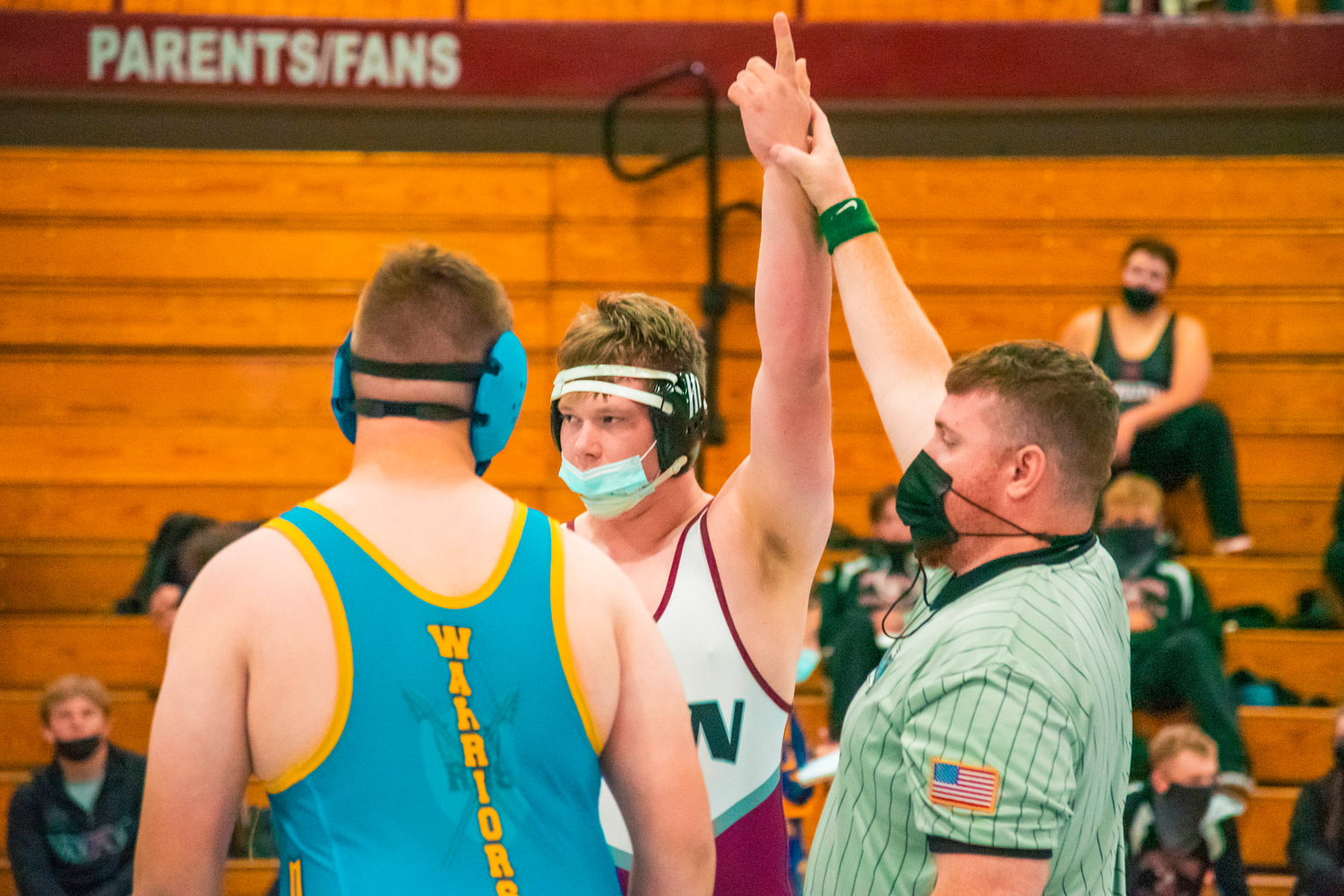 W.F. West’s Bryson Boyd raises his arm after winning a match while wrestling 285 during Sub-Districts Saturday morning in Chehalis.