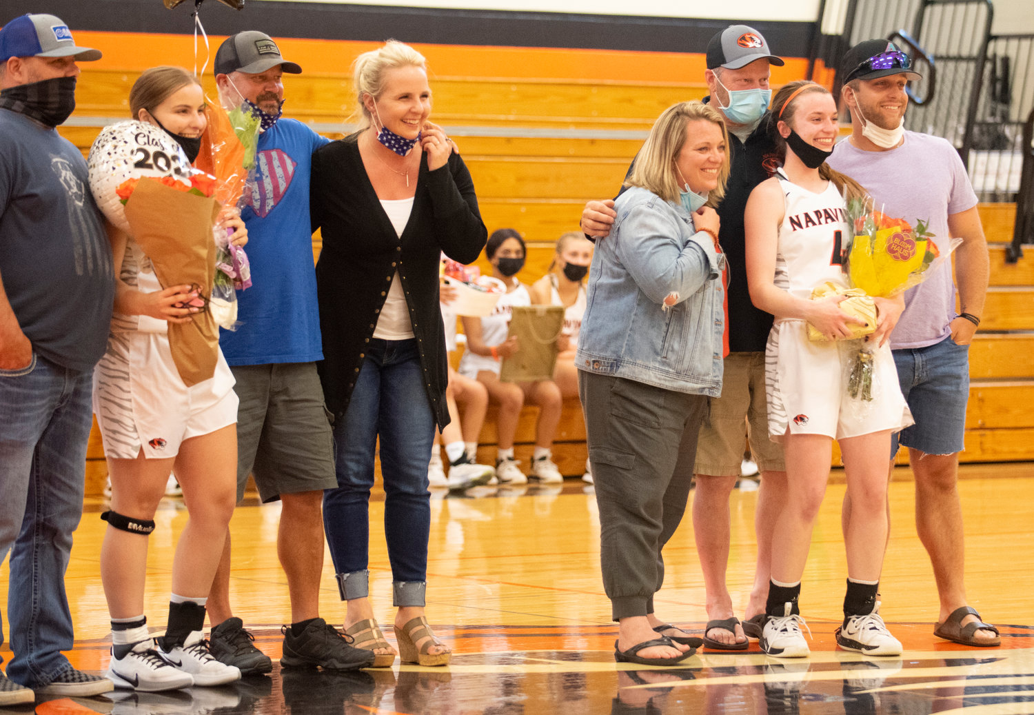 Napavine's Rae Sisson, left, and Vannie Fagerness, right, are honored on senior night Monday.