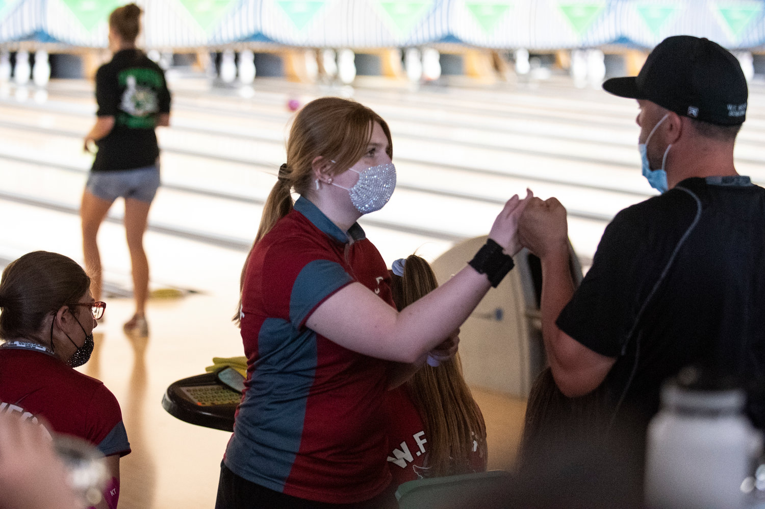 W.F. West sophomore Piper Chalmers gets a fist bump after bowling a strike on Monday at Westside Lanes in Olympia.
