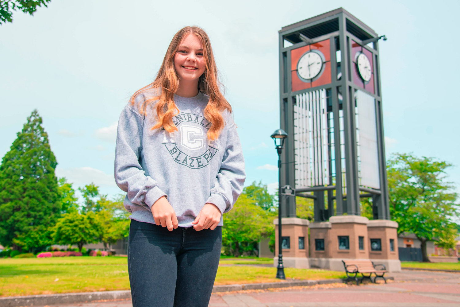 Maddy Casper smiles and poses for a photo in front of the clock tower at Centralia College last week.